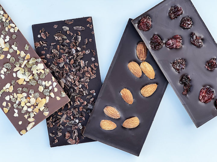 LEDGES Chocolate Bars in four flavors: Milk Chocolate Ginger Cashew, 70% Colombian Dark Chocolate with Cocoa Nibs, Roasted Almonds and Door County Cherries