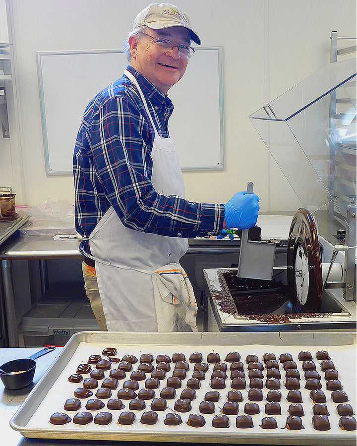 Stan Kitson, Chief Chocolatier at Driftless Chocolates, creating chocolates.